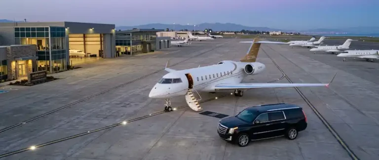 A luxury black car fleet, including Escalades and a Sprinter van, meets a private Global 8000 jet on the tarmac for seamless executive transfers between Orange County to and from LAX