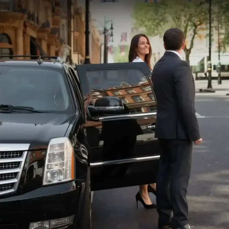 Professional chauffeur opening the door of a luxury SUV for a Palm Springs Limo service airport transfer.