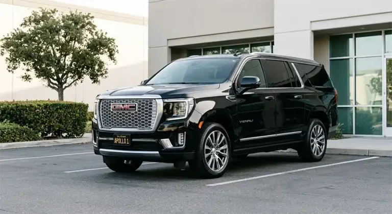 Black 2024 GMC Yukon XL luxury SUV part of the Apollo Regional Transport executive fleet parked in a professional setting.